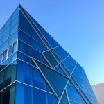Striking blue glass building against a clear sky in Hải Châu, Vietnam.